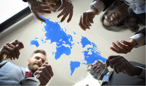 Business people hold map of the world