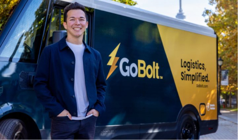 Mark Ang, co-founder of GoBolt, smiling in front of a truck with the GoBolt logo and slogan.